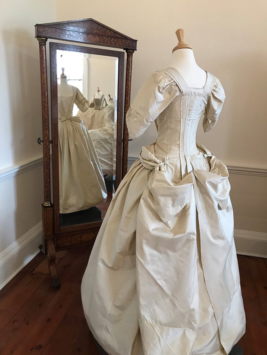 The back of a cream Mantua dress, part of ‘A Dress Fit for a King’ exhibition at Berrington Hall, Herefordshire, UK.