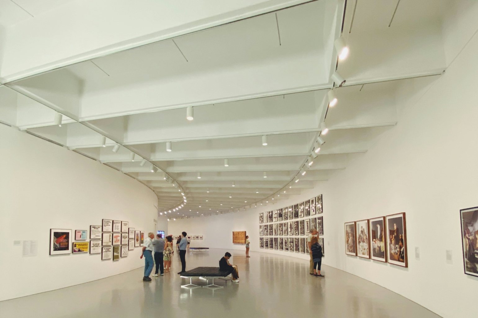 Art gallery setting featuring track lighting in the curved ceiling